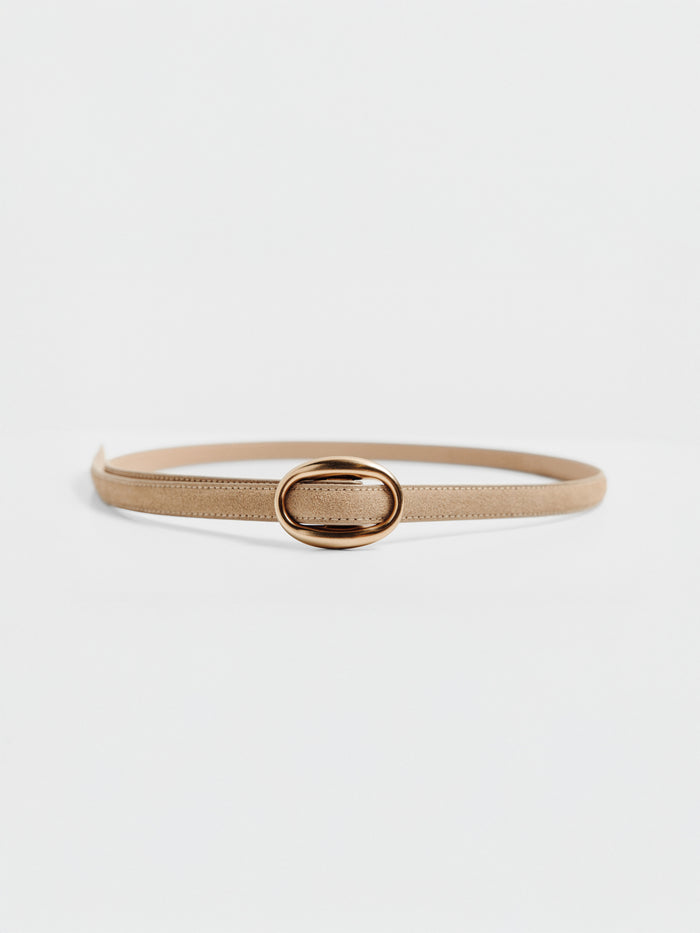 Tan suede belt with an oval gold buckle, looped on a plain background