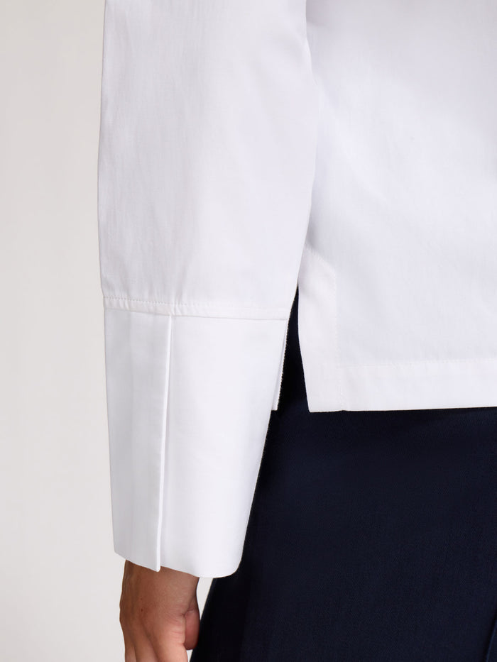 Close-up of the cuff detail on a white popover shirt sleeve