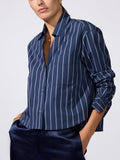 Model wearing the Everyday cropped shirt in navy Hartford stripe with a navy satin skirt