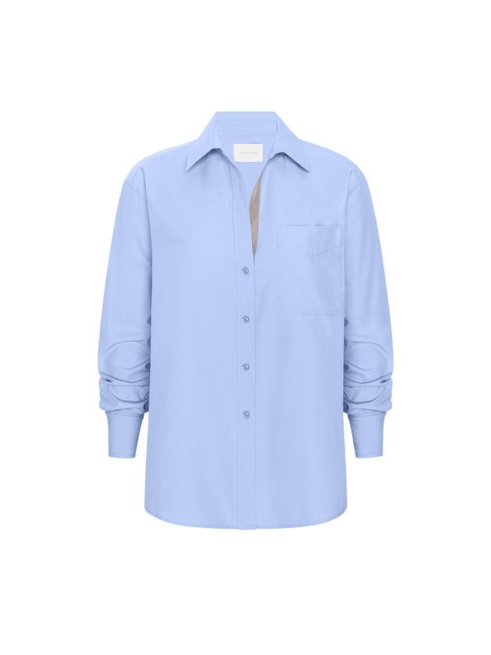 Light blue long-sleeve button-front shirt with a chest pocket on a white background