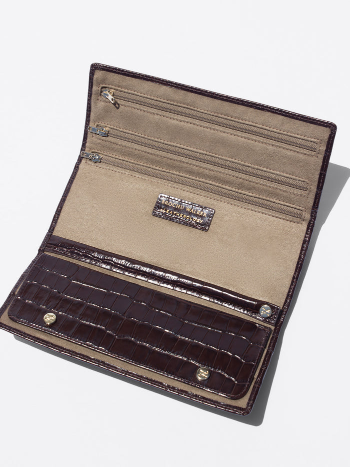 Open long wallet in dark brown crocodile-embossed leather with a beige suede interior showing multiple card slots and a zip compartment