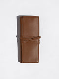 Cognac brown Brochu Walker Leatherology wallet standing upright with its wraparound tie closure
