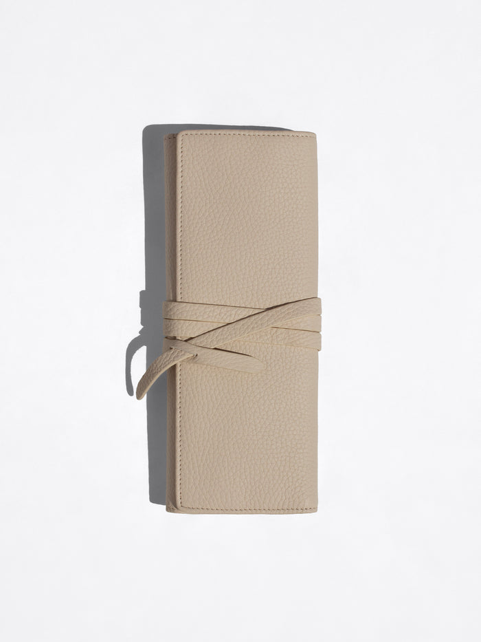 Beige Brochu Walker Leatherology wallet standing upright with its wraparound tie closure