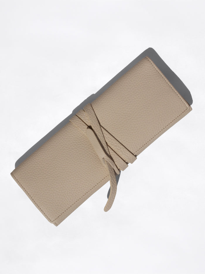 Closed Brochu Walker Leatherology wallet in beige pebbled leather with a wraparound tie closure