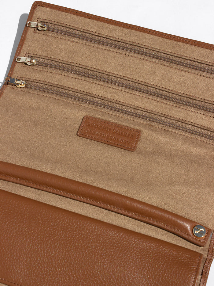 Open cognac brown Brochu Walker Leatherology wallet showing interior zip pockets and logo patch