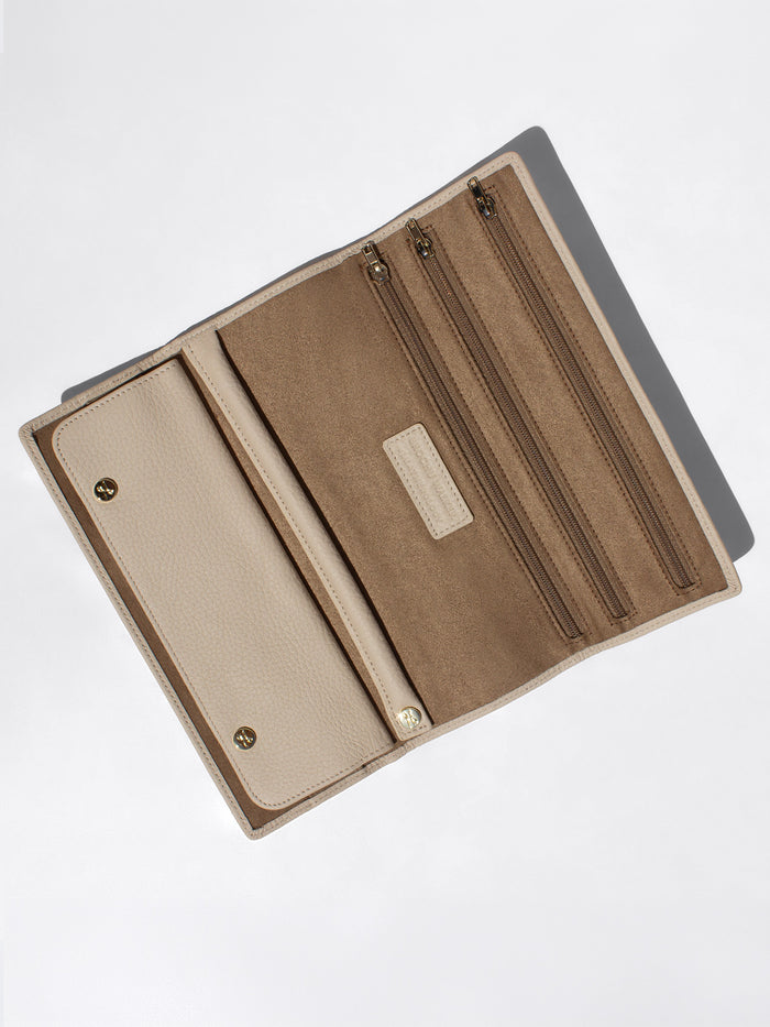 Open Brochu Walker Leatherology wallet showing multiple zip pockets and card slots with tan suede lining