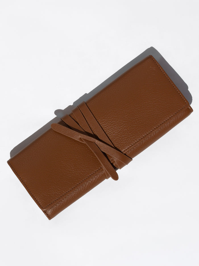 Closed Brochu Walker Leatherology wallet in cognac brown pebbled leather with a wraparound tie closure