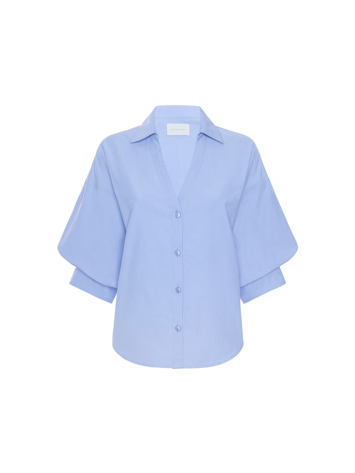 Light blue button-down shirt with balloon sleeves and a point collar, product shot on white background