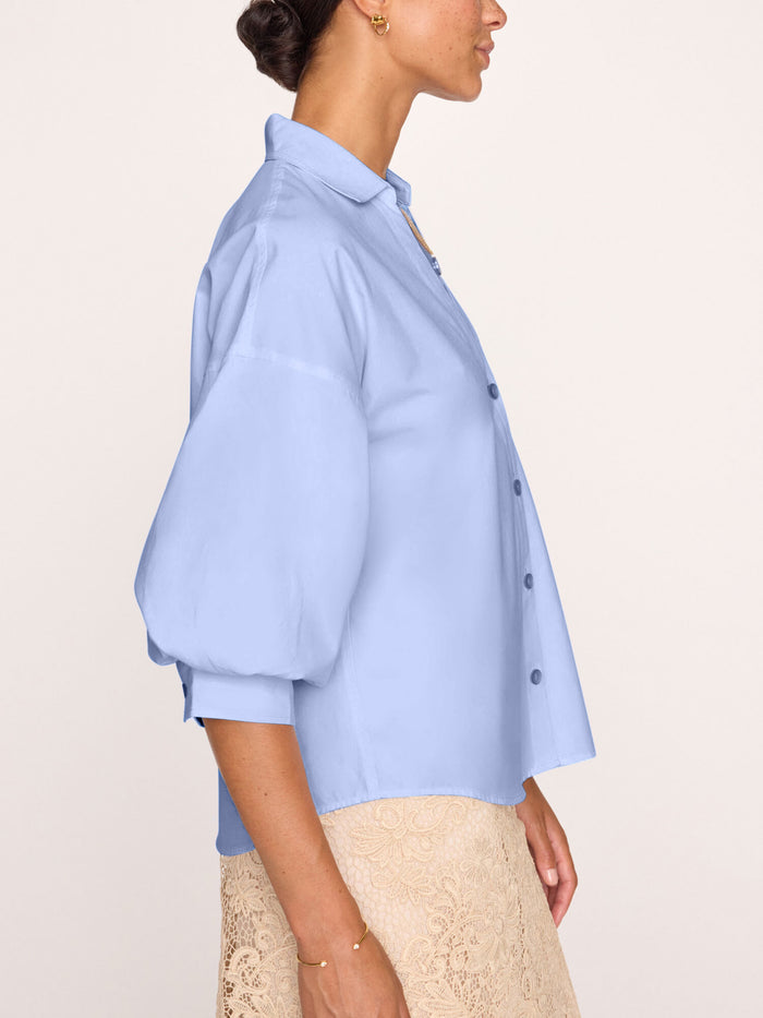 Light blue button-front blouse with balloon sleeves, worn by a model