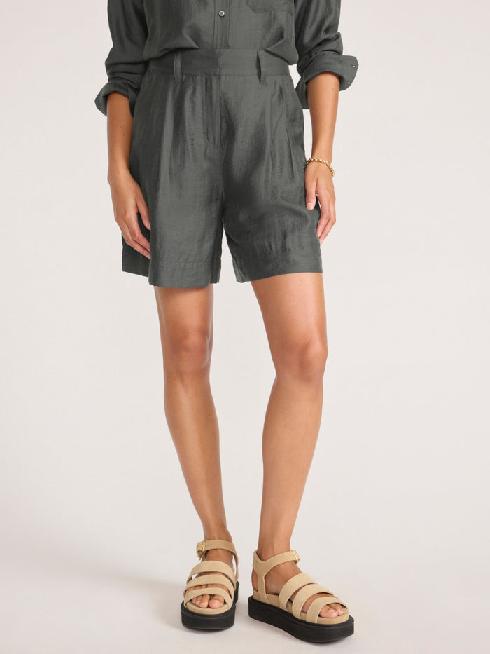 Maris voile short in brownstone, a cropped front view of the pleated shorts paired with platform sandals.