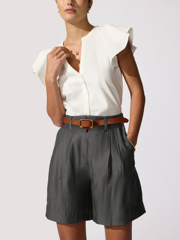 Darya top in ivory, a ruffle-sleeve blouse styled with Maris voile shorts in brownstone and a brown leather belt.