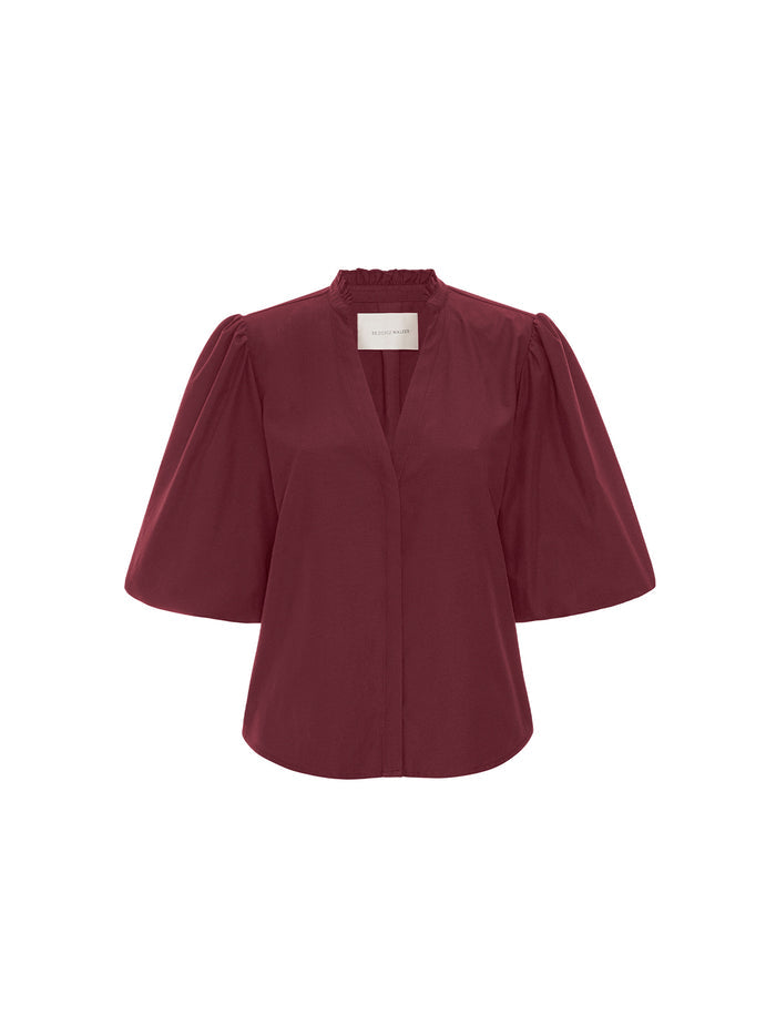 Burgundy puff-sleeve blouse with a ruffled V-neck collar, shown on a white background