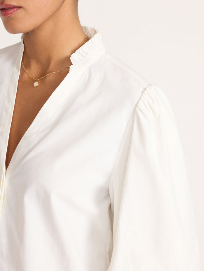 Close-up of the Marla Shirt in Salt White showing its ruffled stand collar and puff sleeve