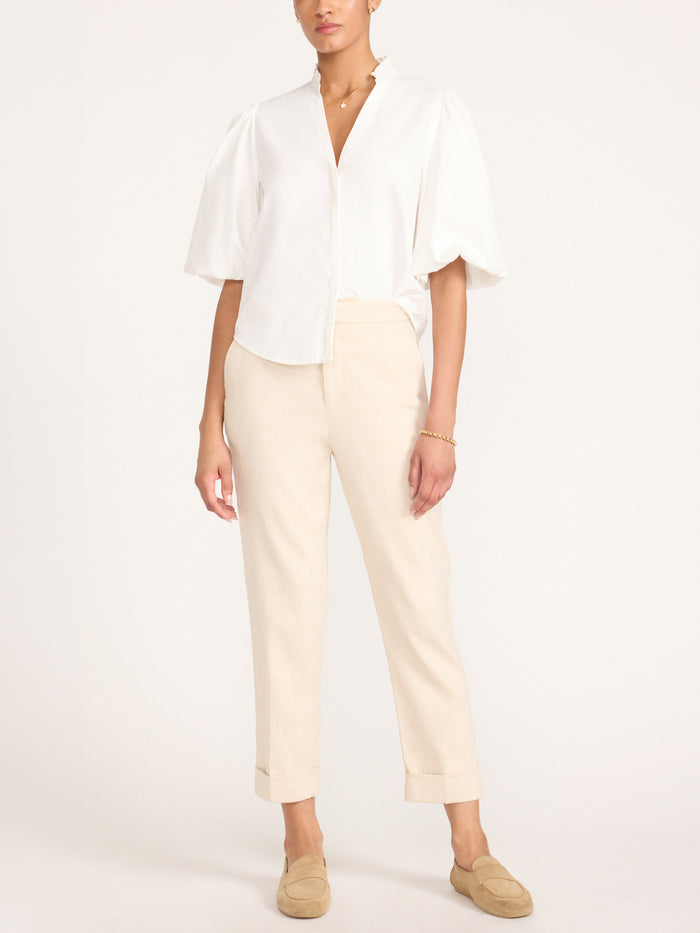 Full-length view of the Marla Shirt in Salt White styled with cropped beige trousers and loafer mules