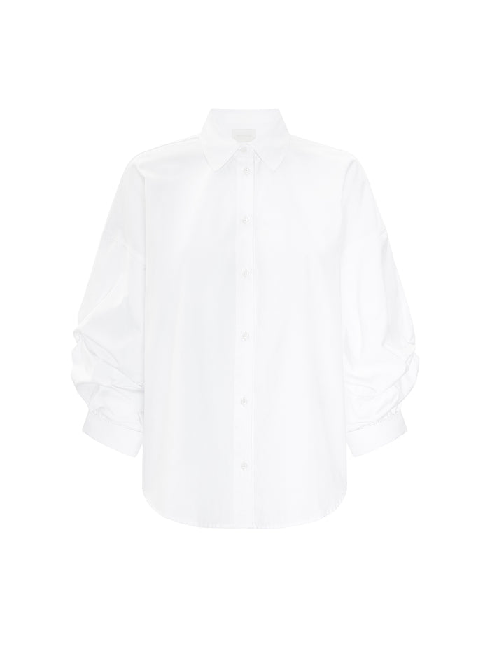 Milan shirt in salt white, an oversized long-sleeve button-up with gathered cuffs, shown flat on a white background.