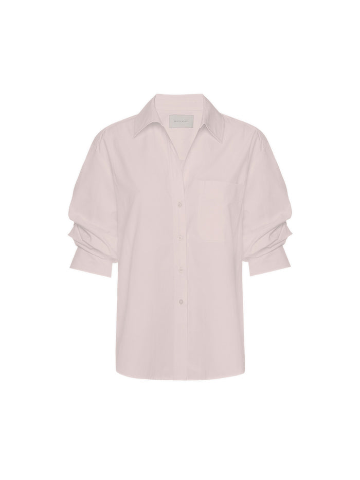 Light pink long-sleeve button-up shirt with a chest pocket and rolled cuffs, shown against a white background.