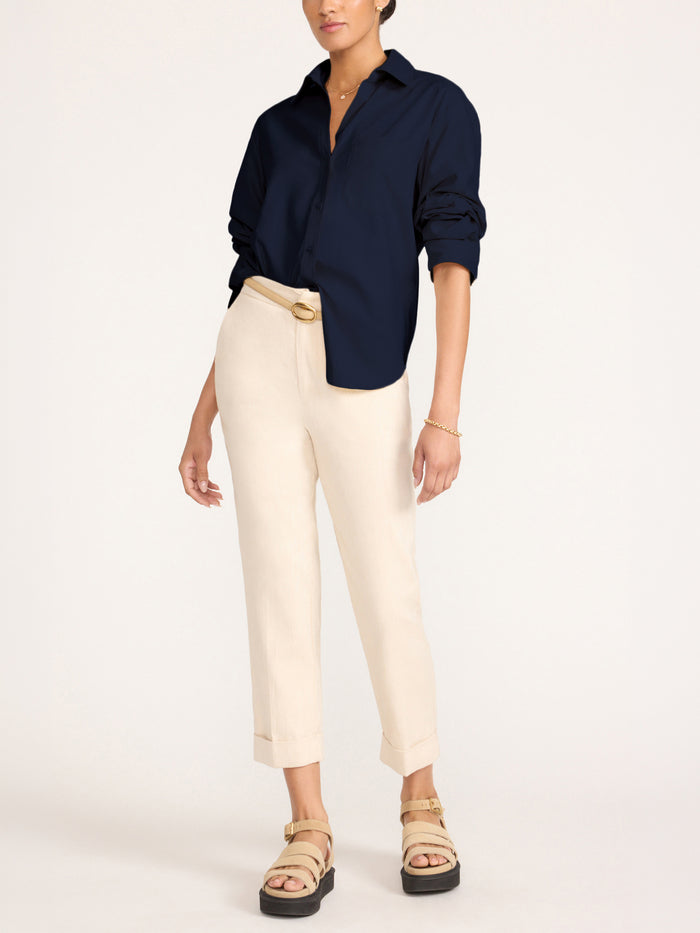 Button-down shirt in navy, styled with cream cropped trousers and beige platform sandals