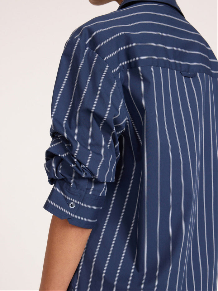 Pia shirt in Hartford stripe, close-up of navy blue button-up shirt with white pinstripes and rolled-up sleeve