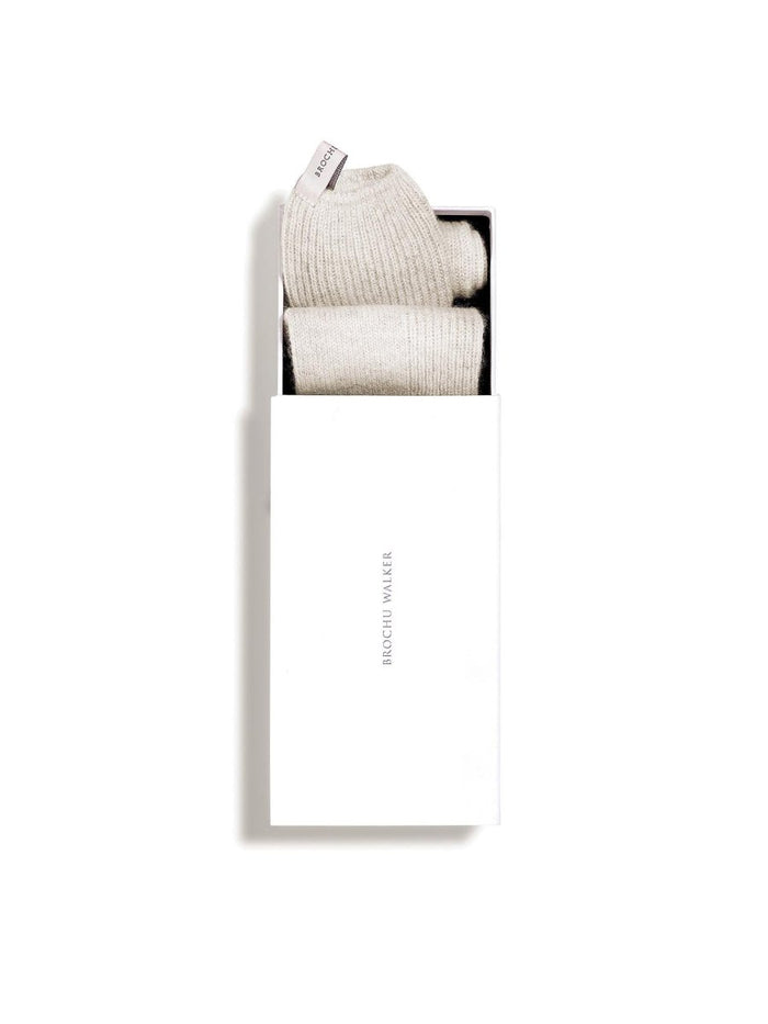Ribbed cashmere socks in mist mélange folded inside a white Brochu Walker gift box.