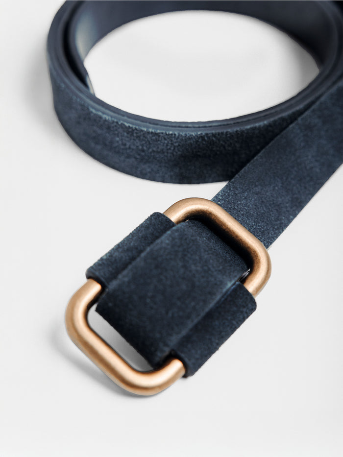 Navy suede belt with a gold square buckle, coiled on a plain background