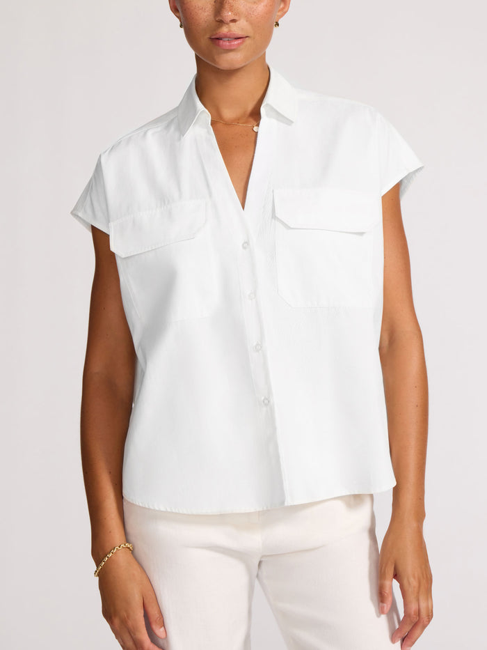 Model wearing a white short-sleeve shirt with two chest pockets, front view