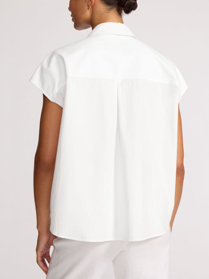 Back view of a model wearing a white short-sleeve shirt