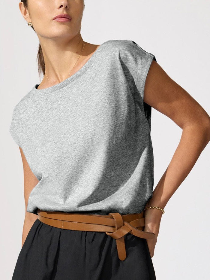 Woman styling the Loti Eyelet Bubble Skirt in Black Onyx with a grey tee and brown leather tie belt